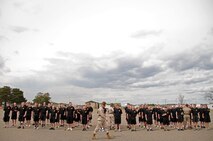 Senior drill instructor Staff Sgt. Brody V. Goldthwaite, 27, from St. Charles, Ill., demonstrates a marching movement while senior drill instructor Staff Sgt. Salvador Moralessolis and drill instructor Sgt. Michael S. Bachicha correct members of the Delayed Entry Program out of Recruiting Substation Burnsville at the Recruiting Station Twin Cities mini boot camp May 6. For additional imagery from the event, visit www.facebook.com/rstwincities.