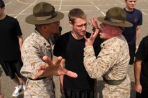 Senior drill instructor Staff Sgt. Salvador Moralessolis and drill instructor Sgt. Bryce E. Torrence explain to David W. Brown III, 20, from Barnesville, Minn., that it's not polite to look directly at them while attending the Recruiting Station Twin Cities mini boot camp May 6. Brown is a 2010 Barnesville High School graduate. For additional imagery from the event, visit www.facebook.com/rstwincities.