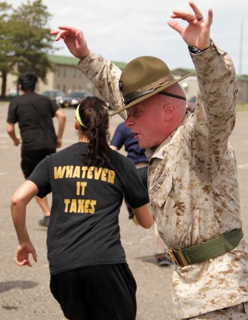 Drill instructor Sgt. Bryce E. Torrence 26, from Caldwell, Idaho, explains the importance of moving quickly while members of the Delayed Entry Program from Recruiting Substation Fargo exit the bus at the Recruiting Station Twin Cities mini boot camp May 6. Moving with speed and intensity was one of many traits the drill instructors discussed during the three-day boot camp. For additional imagery from the event, visit www.facebook.com/rstwincities.