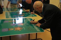 Medal of Honor recipients sign their names onto the signs that will be used for the bridge. This is the first bridge in the nation to be deicated the Medal of Honor Bridge.