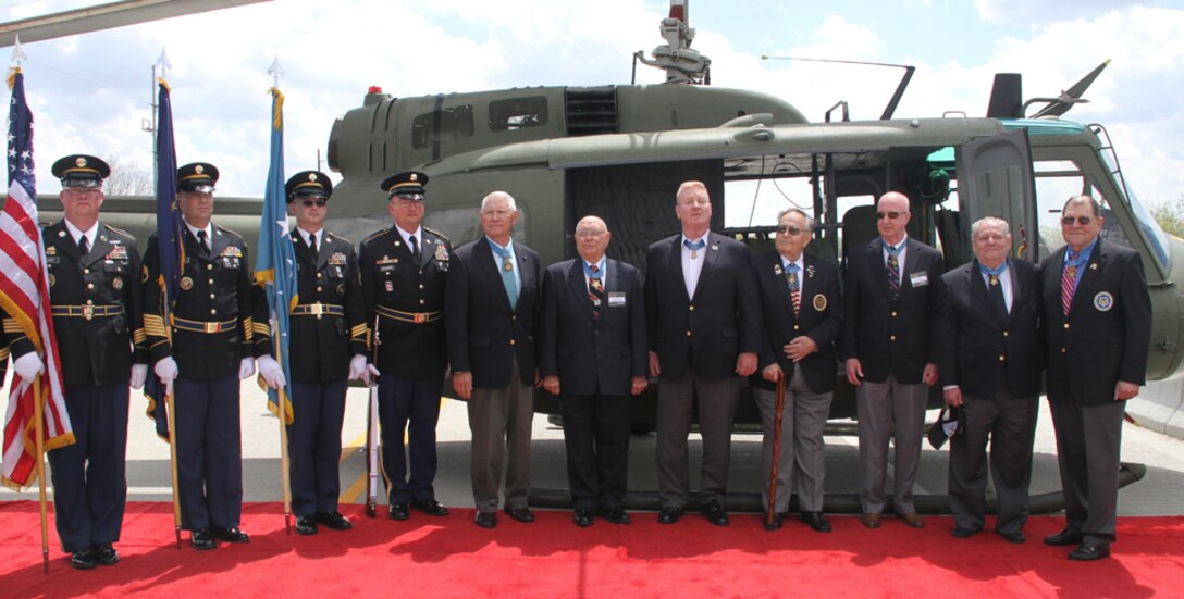 The Army color guard stand and pose for one final picture with the Medal of Honor recipients and the UH-1 Huey helicopter. The Medal of Honor bridge is the first bridge in the nation to be dedicated to the recipients of the nation's highest award for valor in combat.