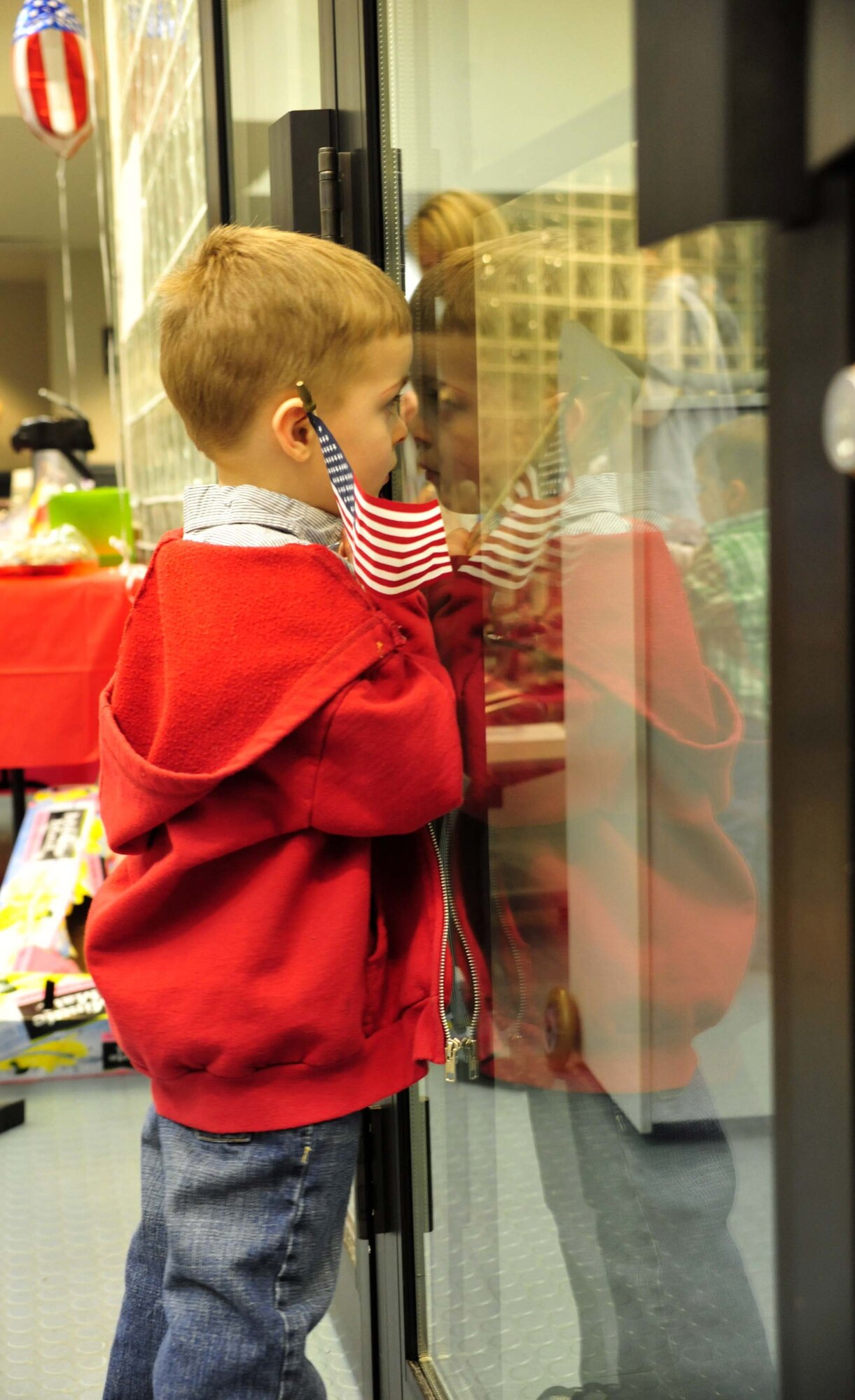 Max Dotson waits for his father, a 7th Airlift Squadron pilot, to return from a 120-day deployment May 5 at Joint Base Lewis-McChord, Wash. (U.S. Air Force photo/Airman 1st Class Leah Young)