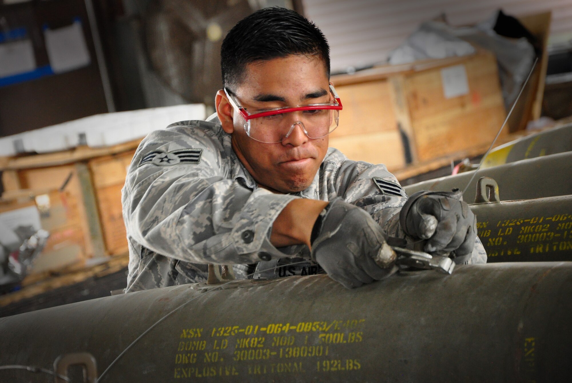 An Airman clips a wire while preparing a bomb for loading onto an A-10 Thunderbolt II May 3, 2011, at Osan Air Base, South Korea. (U.S. Air Force photo/Staff Sgt. Chad Thompson)
