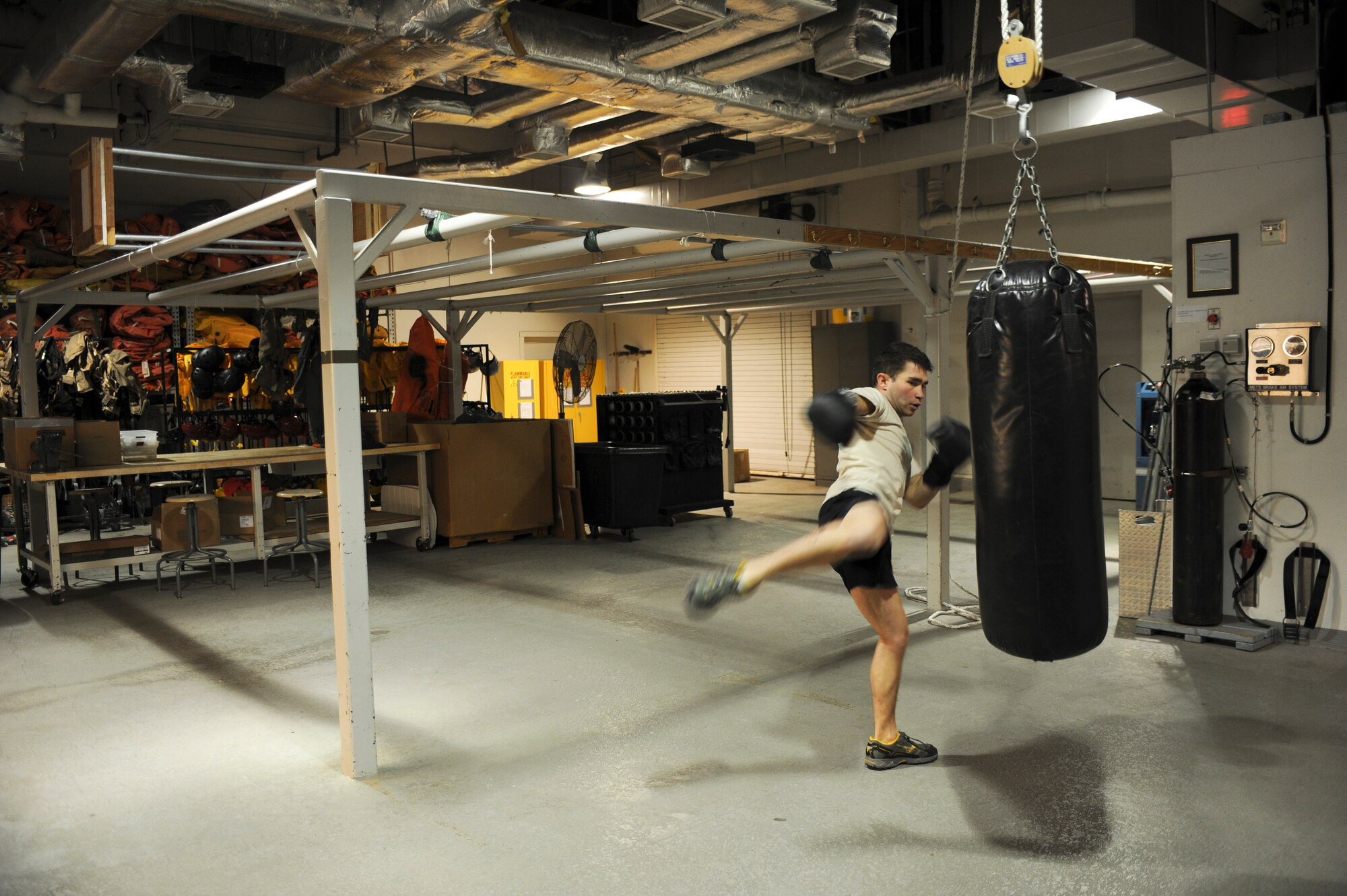 Senior Airman Andrew Lawrence, 66th Training Squadron, water survival instructor, practices kicks and strikes at his shop April 26 in preparation of his mixed martial arts fight at the Northern Quest Casino April 28. He has been fighting for about three years.  