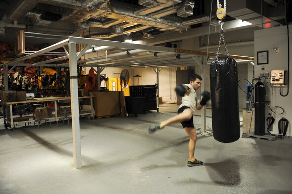 Senior Airman Andrew Lawrence, 66th Training Squadron water survival instructor, practices kicks and strikes at his shop April 26, 2011, at Fairchild Air Force Base, Wash., in preparation for a mixed martial arts fight he had on April 28, 2011. Airman Lawrence has been mixed martial arts fighting for about three years. (U.S. Air Force Photo/Tech. Sgt. J.T. May III) 