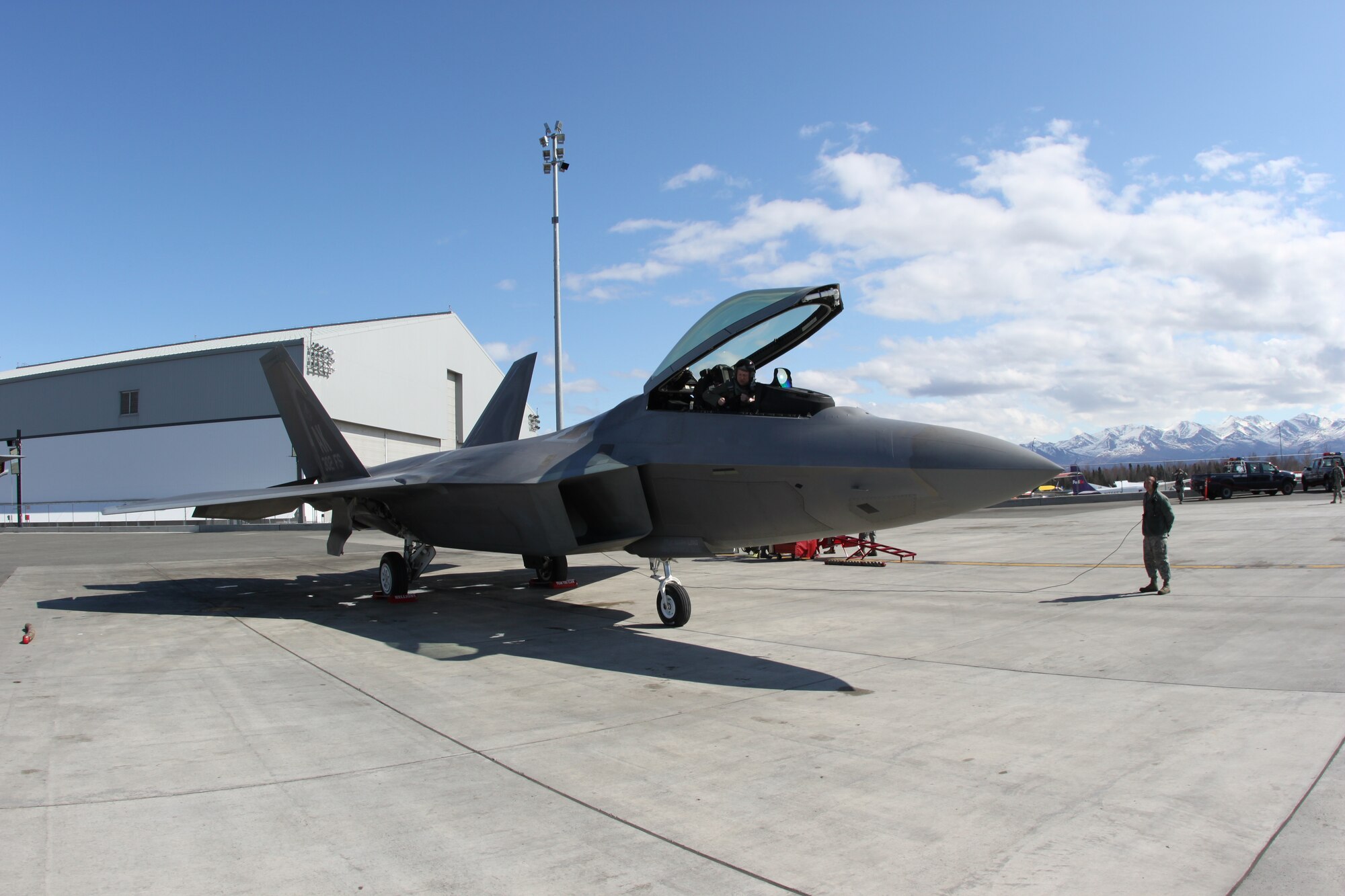 JOINT BASE ELMENDORF-RICHARDSON Alaska--Airman 1st Class Christopher O'Brien, a Reserve Airman in the 477th Fighter Group, looks on as Reserve F-22 pilot Maj. Kevin Sutterfield prepares to fly the jet back to Joint Base Elmendorf-Richardson after the Alaska Aviation Trade Show this past weekend. Members of the Air Force Reserve's 477th Fighter Group took the jet to be a part of the show that included more than 275 vendors and was attended by more than 21,000 visitors. (Air Force Photo/Maj. Lisa Reaver)