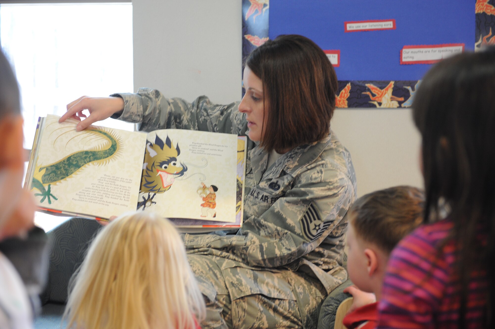 Tech. Sgt. Katrina MacDonald, 28th Bomb Wing Staff protocol assistant, reads to children at the Child Development Center May 4, 2011 at Ellsworth Air Force Base, S.D. Sergeant MacDonald and other Airmen read a variety of books all with the same concept, “We are all different, we’re all the same,” focused primarily on the diversity of our culture. (U.S. Air Force photo/Senior Airman Adam Grant)  