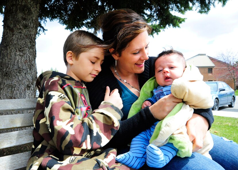 Mrs. Jenevra Watkins, and her sons Quintus, 23 months-old and Antonio, 9 years-old  huddle together at the Airman Family & Readiness Center at Fairchild Air Force Base, Wash., April 28. The family was stationed in Japan and evacuated shortly after the earthquake in March. (U.S. Air Force photo/Airman 1st Class Taylor Curry)