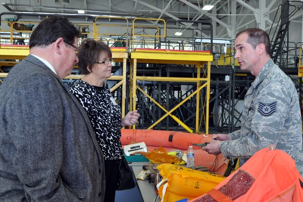 YOUNGSTOWN AIR RESERVE STATION, Ohio - Air Force Reserve Tech Sgt. Philip Walsh, an aircrew flight equipment technician with the 910th Operations Support Squadron, shows a military compass to members of the Youngstown-Warren Regional Chamber of Commerce during an after-work mixer here, May 5. The purpose of the event is to build advocacy for the 910th Airlift Wing, based here, and the Air Force Reserve among civic and business leaders in the Mahoning Valley and Northeast Ohio by showcasing the mission capabilities of the 910th. U.S. Air Force photo by Master Sgt. Bob Barko Jr.