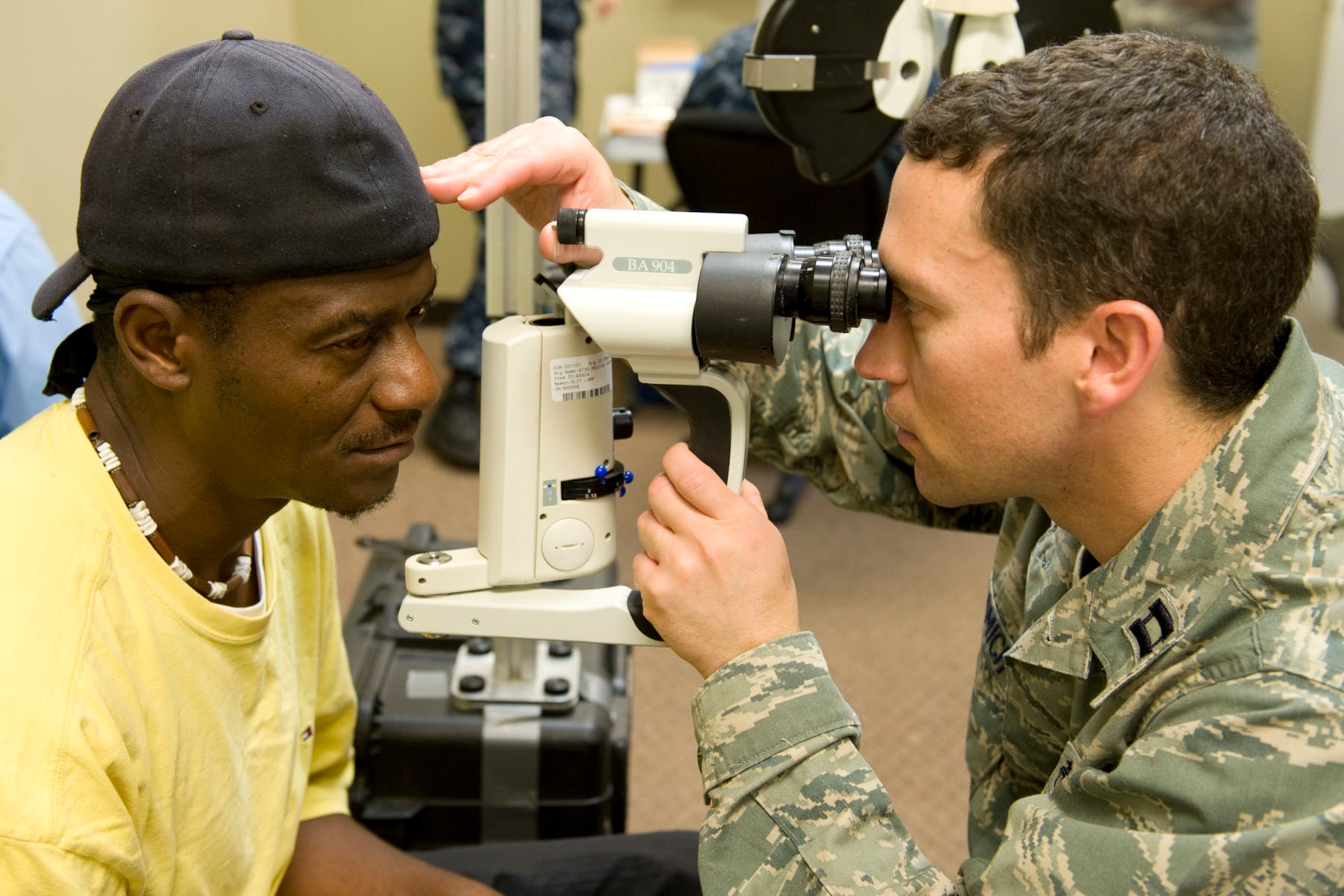 HAYNEVILLE, Ala. - Capt. Andrew Adamich, an optometrist from the 176th Medical Group, Alaska Air National Guard, uses a portable slit lamp biomicroscope on his patient to get a magnified view of his eye, May 4, 2011. Adamich and about 35 other members from the 176th Wing are in Alabama for an Innovative Readiness Training (IRT) mission. The IRT program allows for real world training opportunities for military personnel while providing needed services to under-served communities in the United States.  Alaska Air National Guard photo by Master Sgt. Shannon Oleson.