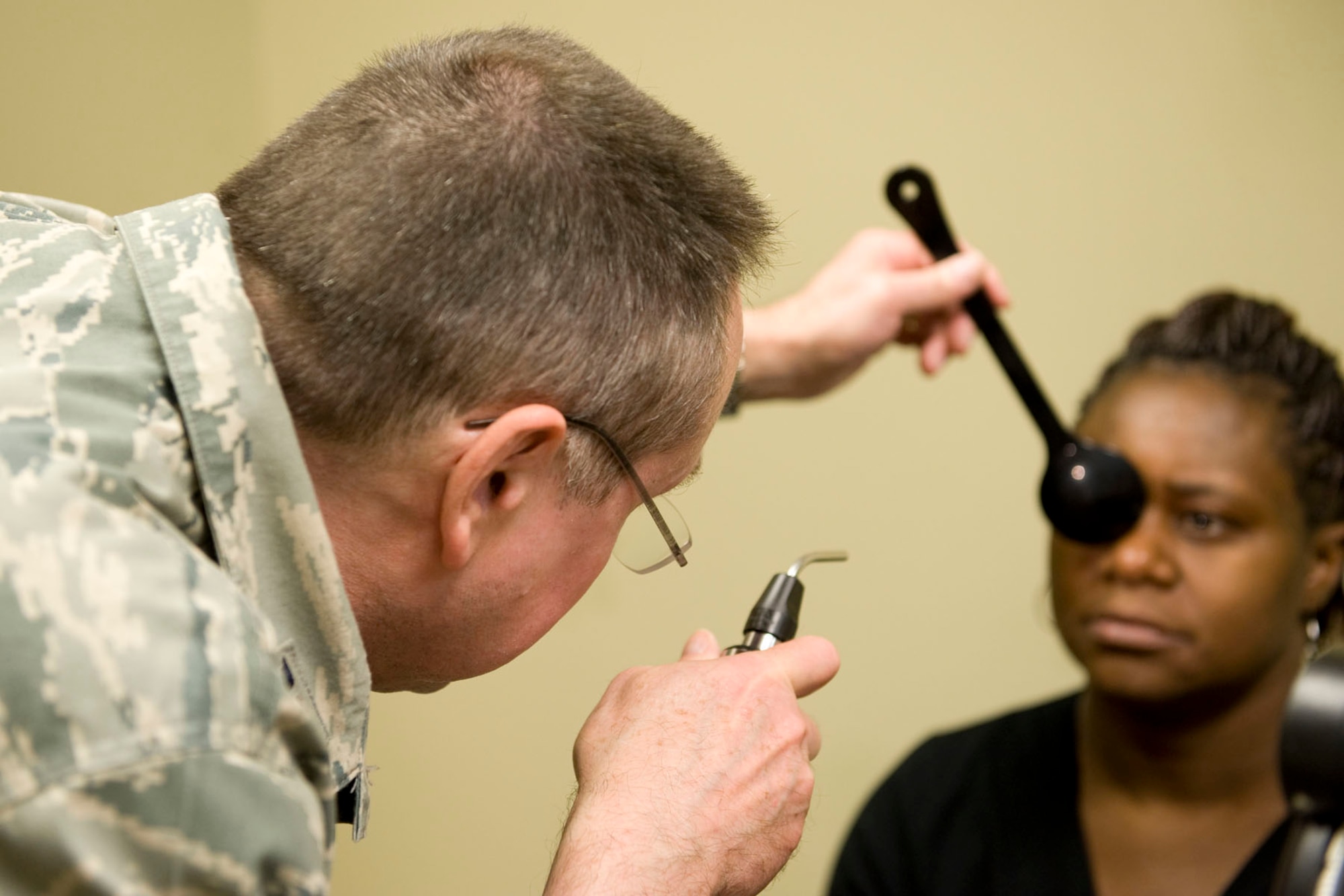 HAYNEVILLE, Ala. - Col. Ronald Kichura, an optometrist from and commander of the 176th Medical Group, Alaska Air National Guard, performs a cover test to check his patient?s eye alignment, May 3, 2011. Kichura and about 35 other members from the 176th Wing are in Alabama for an Innovative Readiness Training (IRT) mission. The IRT program allows for real-world training opportunities for military personnel while providing needed services to under-served communities in the United States. Alaska Air National Guard photo by Master Sgt. Shannon Oleson.