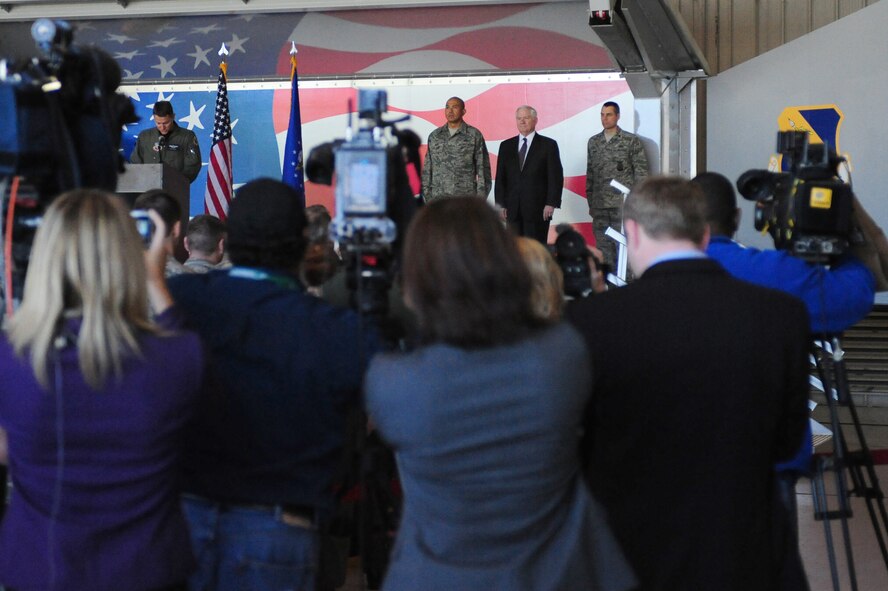 SEYMOUR JOHNSON AIR FORCE BASE, N.C. -- Maj. Nate Hesse reads a Bronze Star Medal citation as Senior Master Sgt. Arnel Abad and Secretary of Defense Robert M. Gates stand at attention here, May 6, 2011. Secretary Gates presented the medal to Sergeant Abad for his accomplishments during a recent deployment to Afghanistan.(U.S. Air Force photo/Senior Airman Rae Perry)(RELEASED)