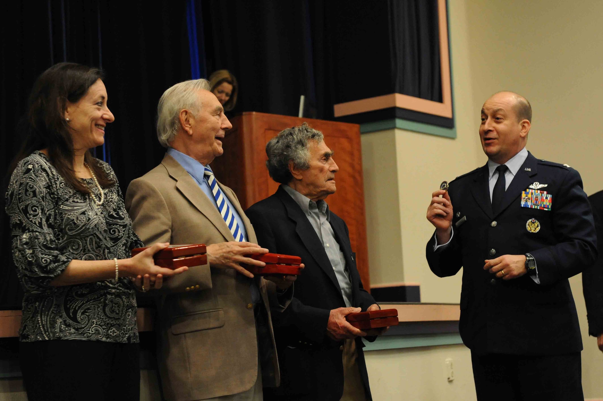 U.S. Air Force Col. Mustafa Koprucu, Commander of the 505th Command and Control Wing, presents guest speakers Dr. Lori Ripps, Joseph Callewaert and Herman Snyder with gifts during the Holocaust Remembrance ceremony, Hurlburt Field, Fla., May 5, 2011. The ceremony shed light on the systematic, state-sponsored persecution and murder of approximately six million Jews by the Nazi regime. (U.S. Air Force photo/Airman 1st Class Caitlin O'Neil-McKeown)