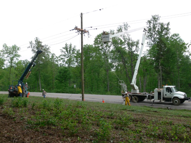 Tom Payne (in bucket), John Williams, Jason Lusk and James Melton from Power Control try to restore power on Pumping Station Road after the Apruil 27 storm. (Photo provided) 