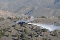 GOWEN FIELD, Idaho -- A 302nd Air Expeditionary Group Modular Airborne Fire Fighting System-equipped C-130 flies over the plains of Idaho to perform an air drop on a simulated fire. From May 2 through May 6 Air Force Reserve and Air National Guard members completed their annual initial and re-currency certification required by the U.S. Forest Service. (U.S. Air Force photo/Tech. Sgt. Rich Kerner)