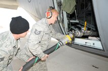 GOWEN FIELD, Idaho – 302nd Air Expeditionary Group personnel load the 3,000 gallon Modular Airborne Fire Fighting System tank with water in preparation for an air drop on a simulated fire. From May 2 through May 6 Air Force Reserve and Air National Guard members completed their annual initial and re-currency certification required by the U.S. Forest Service. (U.S. Air Force photo/Tech. Sgt. Rich Kerner)