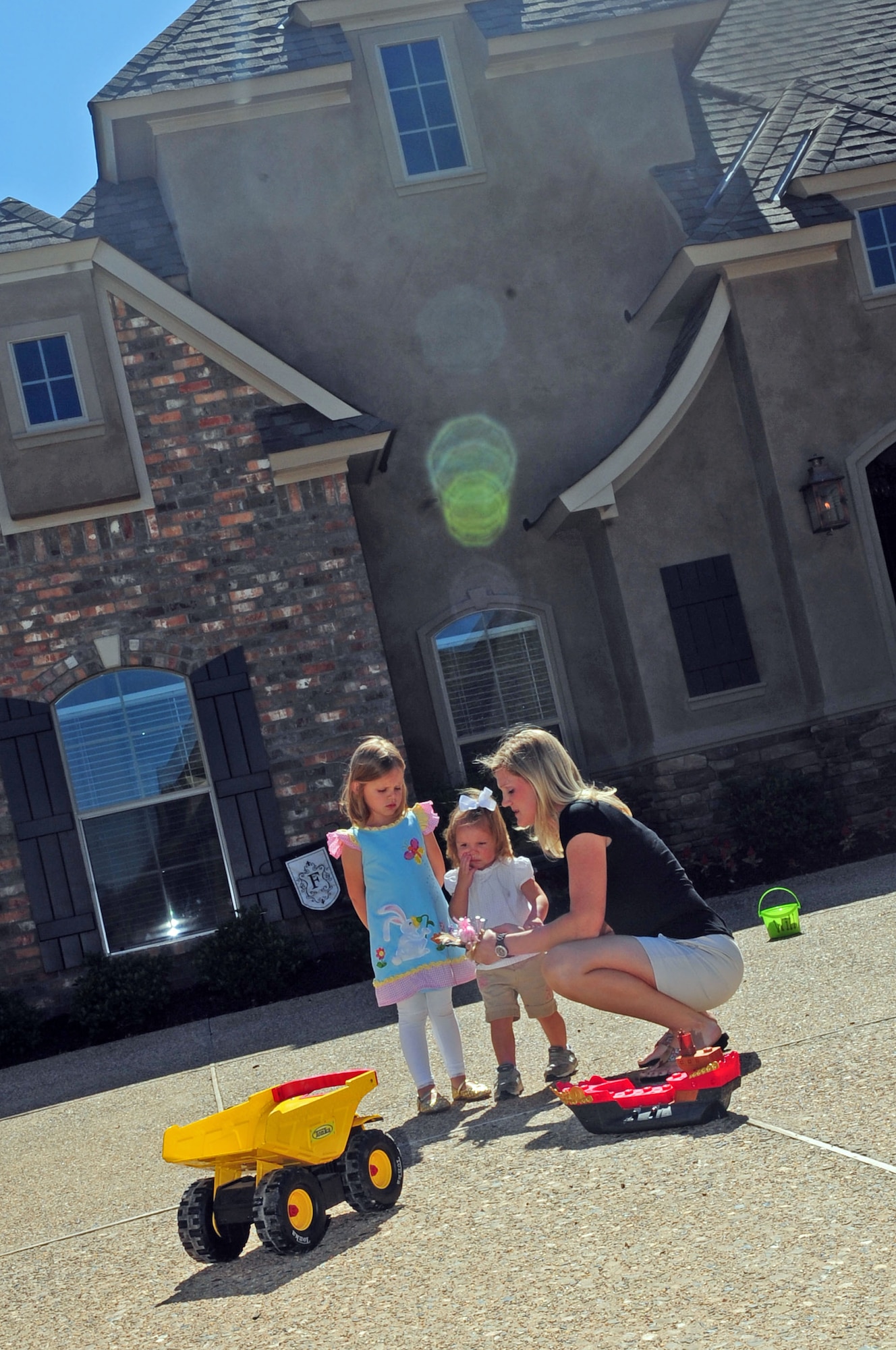 Mrs. Hilary Free calms a conflict between her daughters, Ashlin, 4, and Presley, 1, outside their home in Shreveport, La., April 30. Mrs. Free stays home with her three children who help her with household chores, attend home school classes, assist with bible studies and other church activities and spend quality time playing outdoors together. (U.S. Air Force photo/Senior Airman Joanna M. Kresge) 