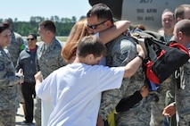 Airmen from the 916th Air Refueling Wing are greeted by their families upon their return from Spain, supporting the international effort over Libya. (USAF photo by Maj. Shannon Mann, 916ARW/PA)