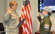 YOUNGSTOWN AIR RESERVE STATION, Ohio—Air Force Reserve Col. Teresa Hams, commander of the 910th Mission Support Group, swears in 11 year-old Ashley Moorhead of Warren during a commissioning ceremony here.  Ashley was sworn in as an honorary Air Force Reserve 2nd Lieutenant and Pilot for a Day May 4, 2011, when she visited the air station for an exciting schedule of events. Ashley is currently receiving treatment for Cerebral Palsy at Akron Children's Hospital Mahoning Valley. 
The purpose of the Pilot for a Day program is to reach out to the community by providing a fun-filled day of activities to children who live with a chronic or life-threatening disease or illness. The Youngstown Air Reserve Station Base-Community Council is the financial co-sponsor of the program.  As part of the program, children are selected to visit the base, receive a genuine aircrew flight suit and other mementos as well as receive an enlightening tour of the base.  Included as part of the tour are a visit to the Life Support shop, firing the Fire Arms Training Simulator, a ride on a base fire truck and being taxied aboard a million C-130 Hercules aircraft down the runway.  U.S. Air Force photo by Maj. Brent Davis
