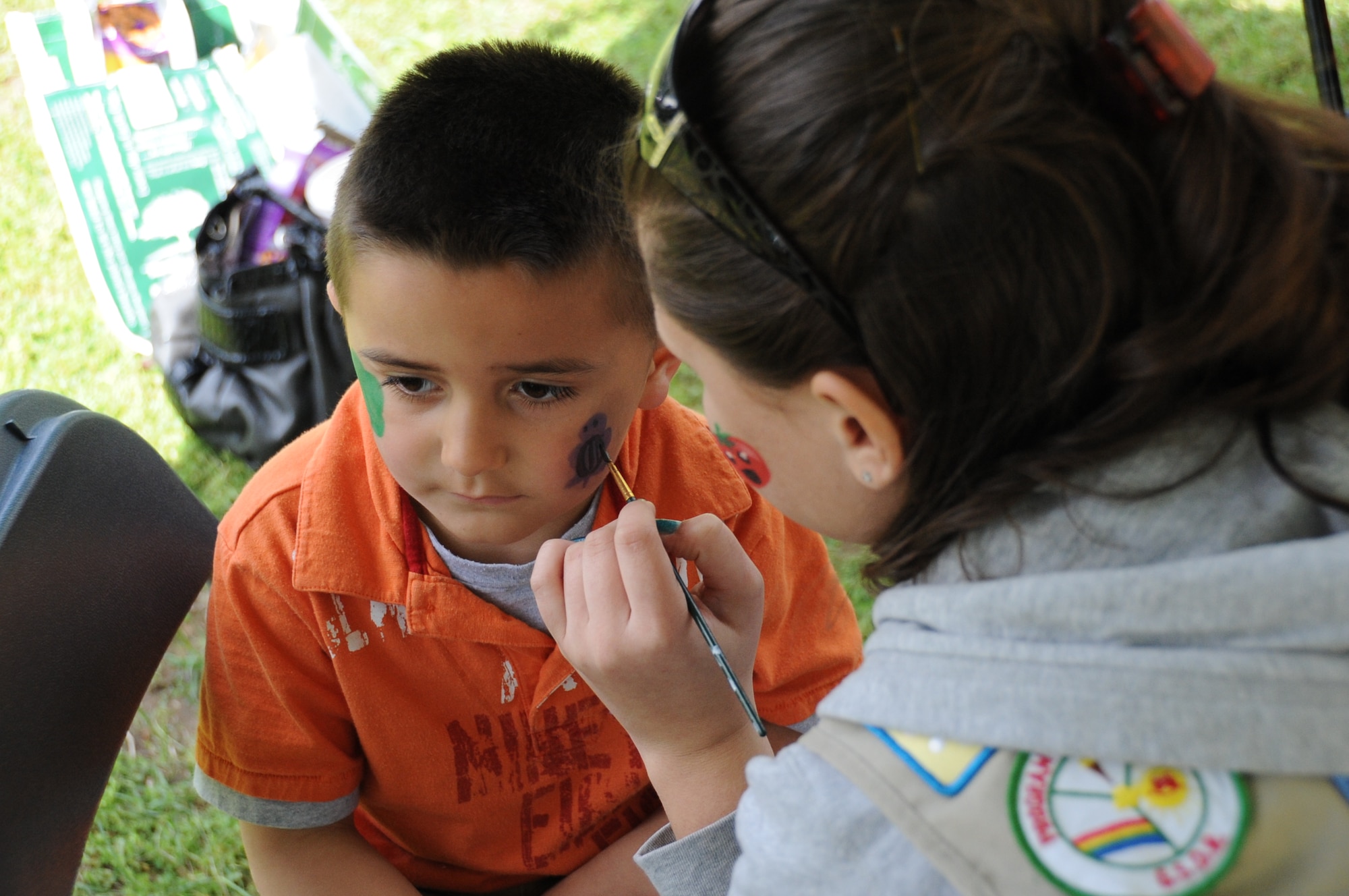 Colin Penry, son of Senior Airman Amanda Mercado, 87th Contracting Squadron, gets a purple turtle painted on his cheek during the Earth Day festivities Saturday at Laurel Pond on Dix. This 6-hour event allowed the joint base community a chance to experience nature at its fullest while learning to how to lessen their negative impact on the environment. (U.S. Air Force photo by Airman 1st Class Bryan Swink/Released)