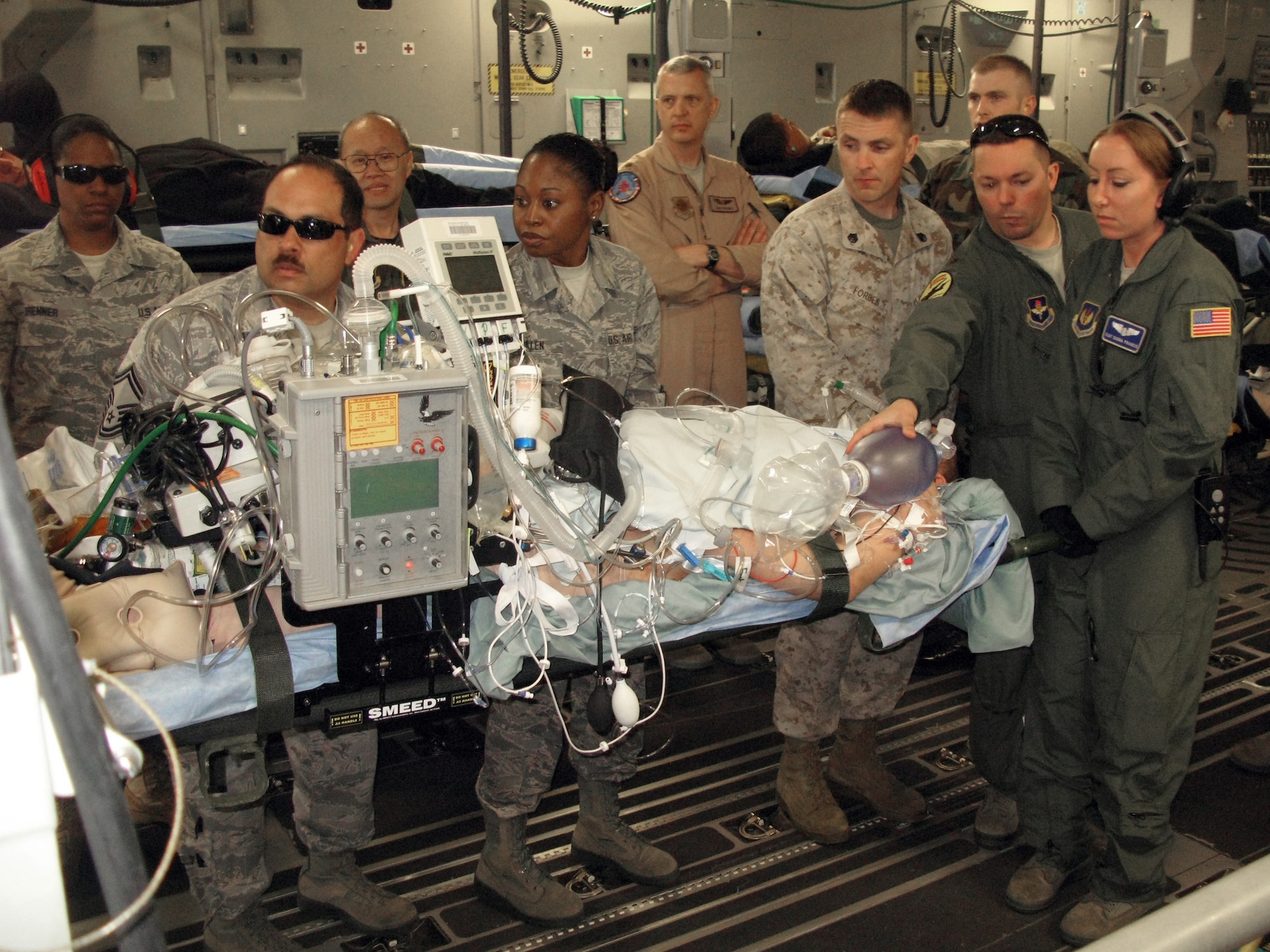 Aeromedical evacuation team members and volunteers at Ramstein Air Base, Germany, position a critically wounded warrior for a flight April 29, 2011, aboard a C-17 Globemaster III to Joint Base Andrews, Md. (Defense Department photo/Donna Miles)