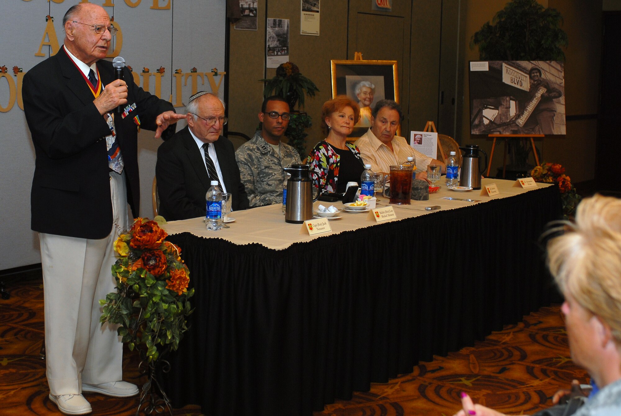 Capt. (Ret.) Jack Nemerov, Holocaust liberator, explains the events that occurred during the liberation of Dachau, a concentration camp in southern Germany, during the 2011 Days of Remembrance exhibit April 28 at Club Five Six. (U.S. Air Force photo by Senior Airman Tracie Forte)