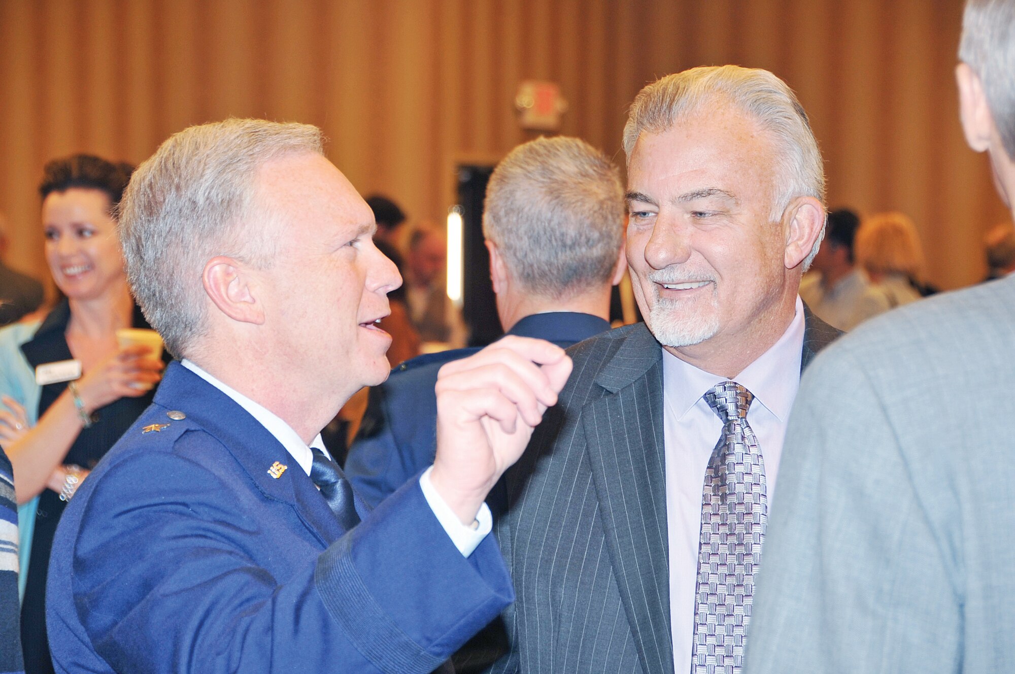 Brig. Gen. John F. Thompson, program executive officer for Strategic Systems at Kirtland AFB, left, and Michael Chase, board member of the Kirtland Partnership Directors Board, visit during the event.