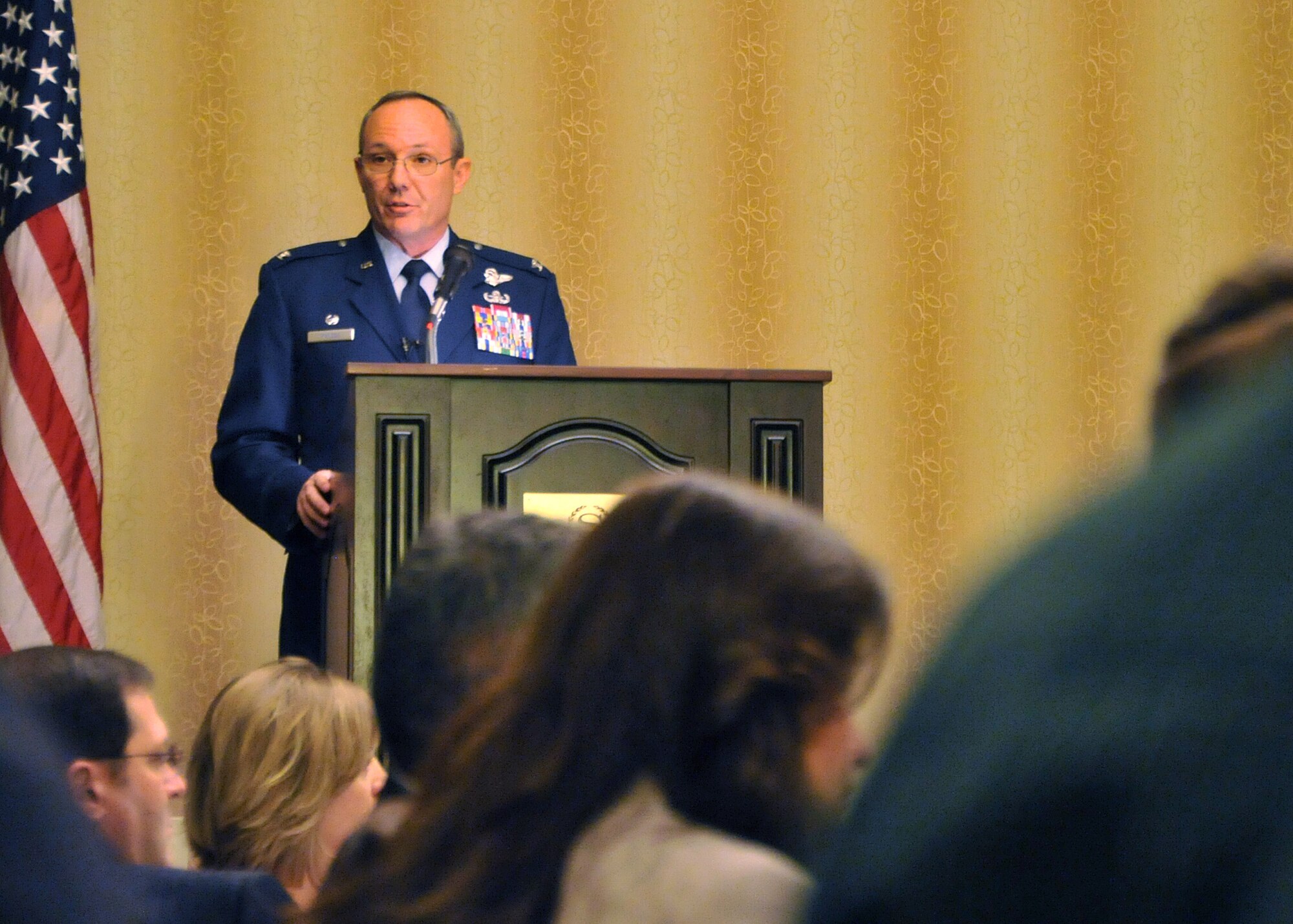 Col. Robert L. Maness, 377th Air Base Wing commander, presents his report at the breakfast event April 28.