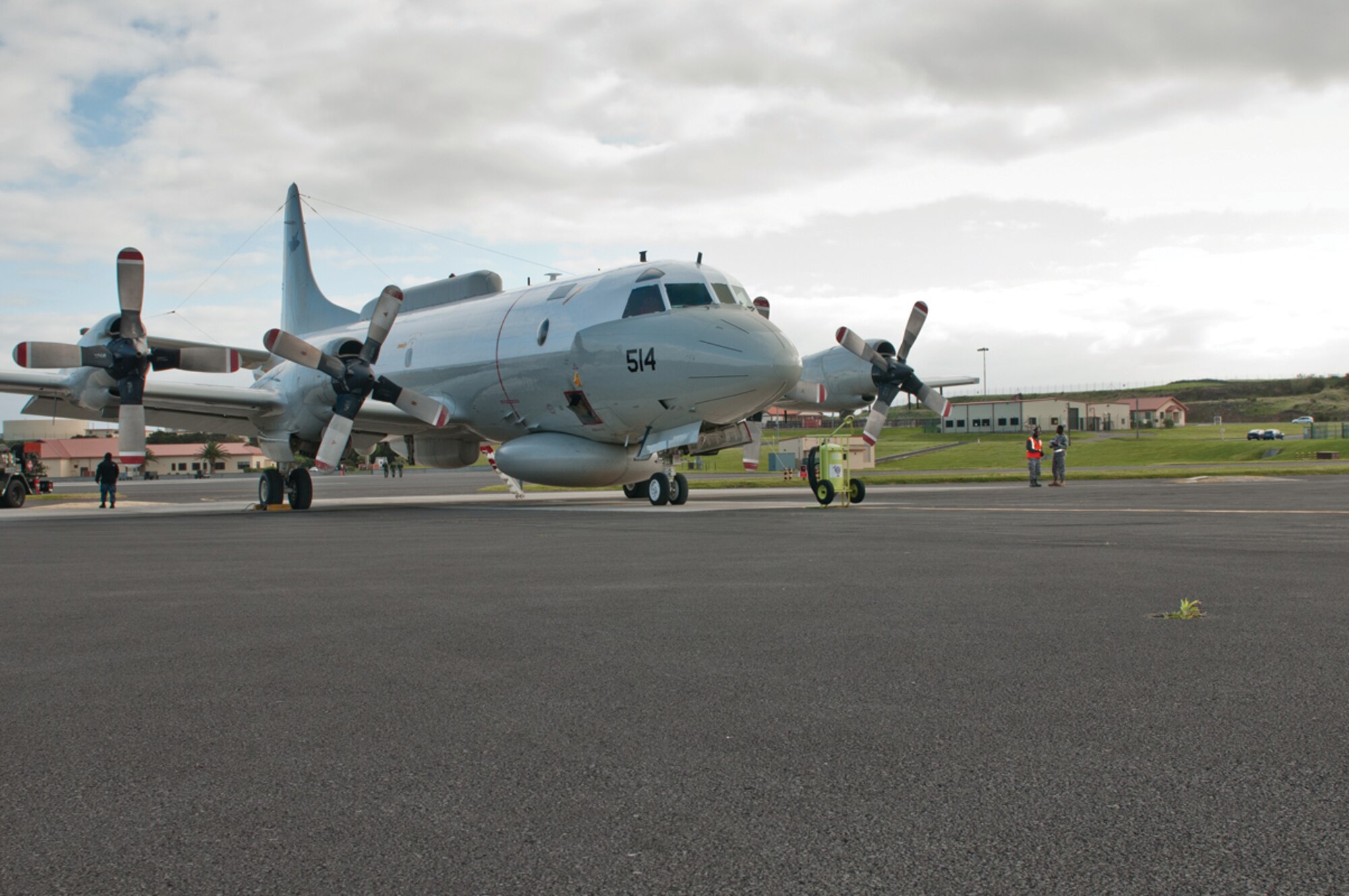 Transient alert Airmen from the 65th Operations Support Squadron, provide parking support for a Navy P-3 Orion during a "gas-n-go" at Lajes Field, Azores, May 3, 2011. The P-3 and its crew were going to Naval Station Rota, Spain. (Photo by Lucas Silva)