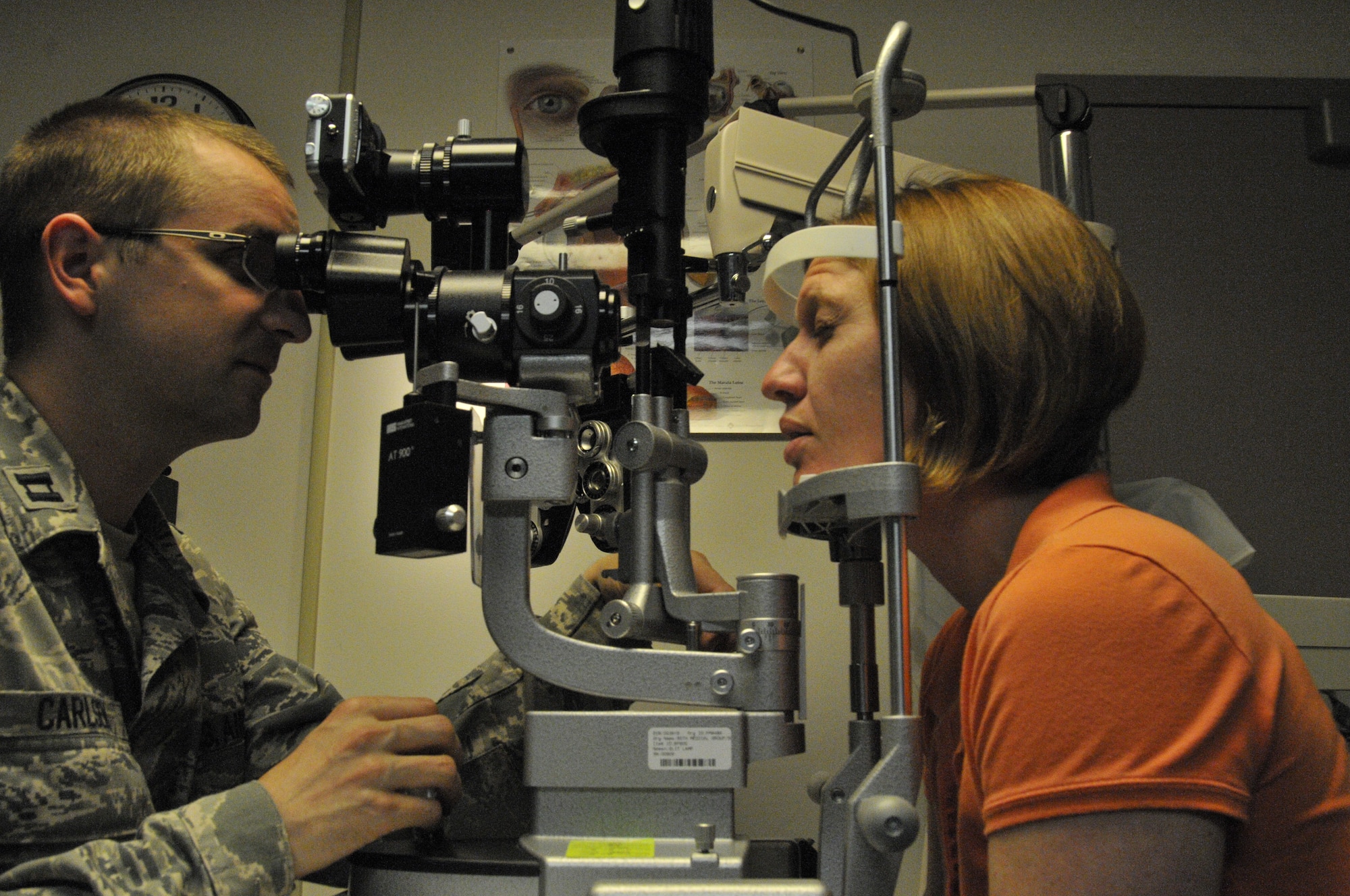 Capt. Robert Carlsen, Lajes Optometry Clinic flight commander, uses a biomicroscope to check Melissa Schmidt’s eyes during a routing ocular test at the Lajes Optometry Clinic April 26, 2011.  The optometry clinic, the primary eye-care provider for members at Lajes, takes care of about 90 patients a month. (U.S. Air Force photo/Staff Sgt. Olufemi Owolabi)