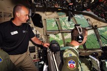 Tim Milligan gets a good look at the northwest Georgia region over the C-130H2 pilot, Capt. Jonathan Lester's shoulder during the Leadership Cobb familiarization flight, May 5.  Participants in Leadership Cobb had this rare opportunity during their visit to the 94th Airlift Wing and Dobbins Air Reserve Base.    (U.S. Air Force photo/ Brad Fallin)