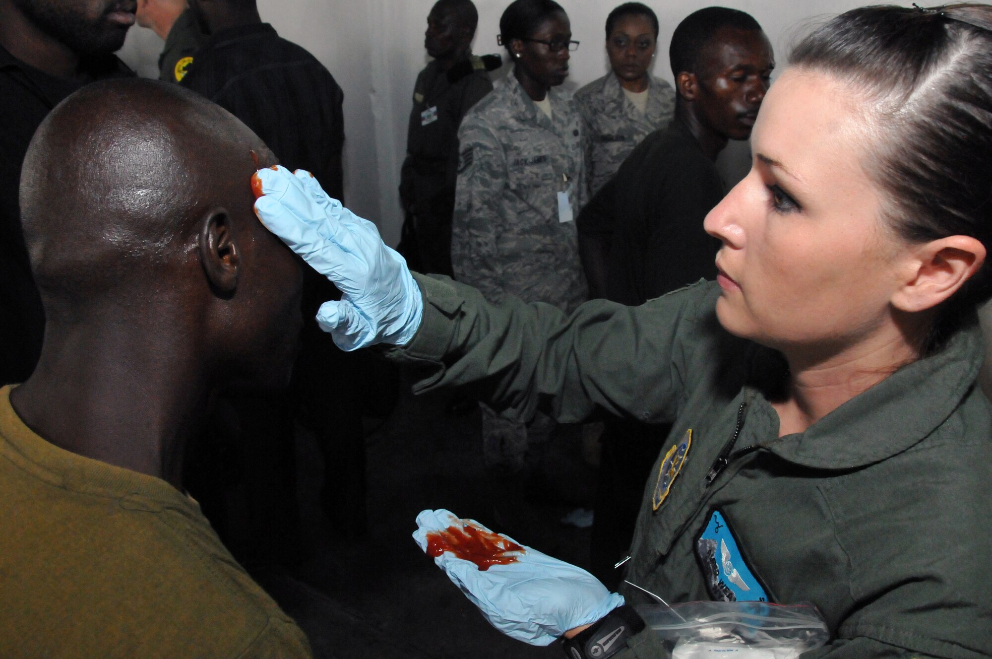 KINSHASA, Democratic Republic of the Congo – U.S. Air Force Staff Sgt. Amber Weaver, an aeromedical evacuation technician with the Wyoming Air National Guard's 187th Aeromedical Evacuation Squadron applies ketchup to an exercise participant during the final mass-casualty exercise of MEDLITE 11, here May 4, 2011. The exercise consisted of a rare earthquake and several of scenarios causing the Democratic Republic of the Congo to activate their quick response force. The casualties were then evacuated on a Georgia Air National Guard C-130 Hercules. (U.S. Air Force photos by Tech. Sgt. John Orrell)