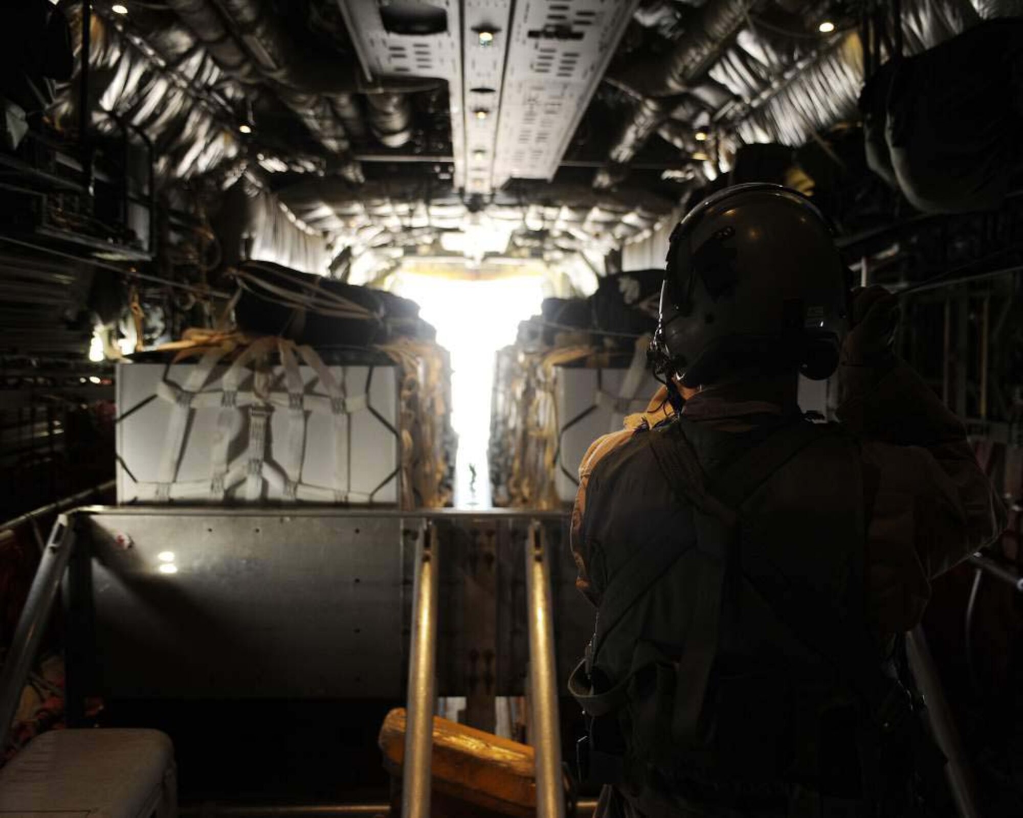A Loadmaster pulls the release cable on an airdrop load from a C-130J Super Hercules May 6, 2011, in Afghanistan. C-130s working out of Afghanistan experience unique wear from sand and rocks and require extra attention from maintainers. The Loadmaster is assigned to the 772nd Expeditionary Airlift Squadron, 451st Air Expeditionary Wing. (U.S. Air Force photo by Senior Airman Willard E. Grande II)