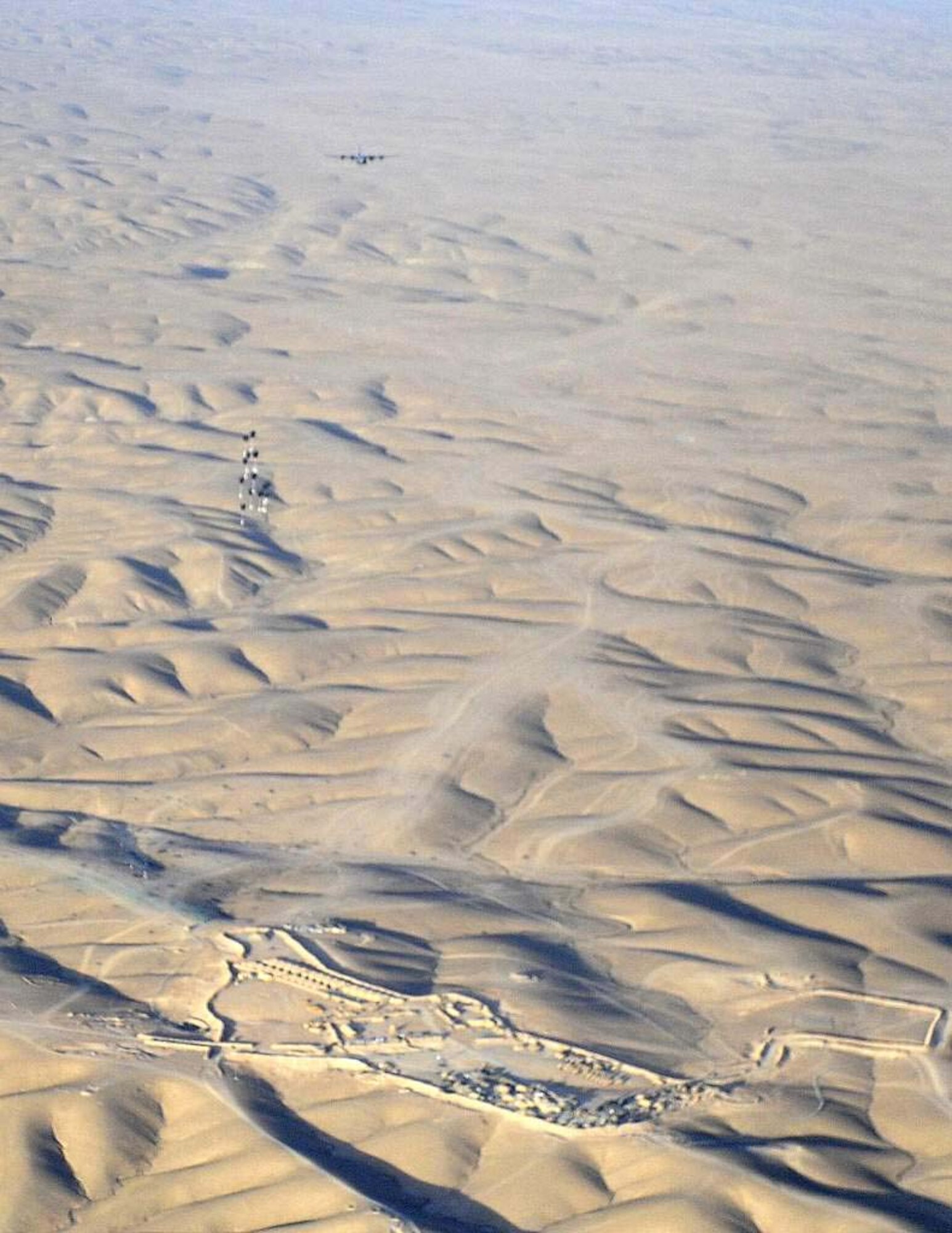 The payload from a C-130J Super Hercules airdrop mission lands on target May 6, 2011, in Afghanistan. C-130s working out of Afghanistan experience unique wear from sand and rocks and require extra attention from maintainers. The C-130J is assigned to the 772nd Expeditionary Airlift Squadron, 451st Air Expeditionary Wing, which made 81 drops during the month of April, 2011. (U.S. Air Force photo by Senior Airman Willard E. Grande II)
