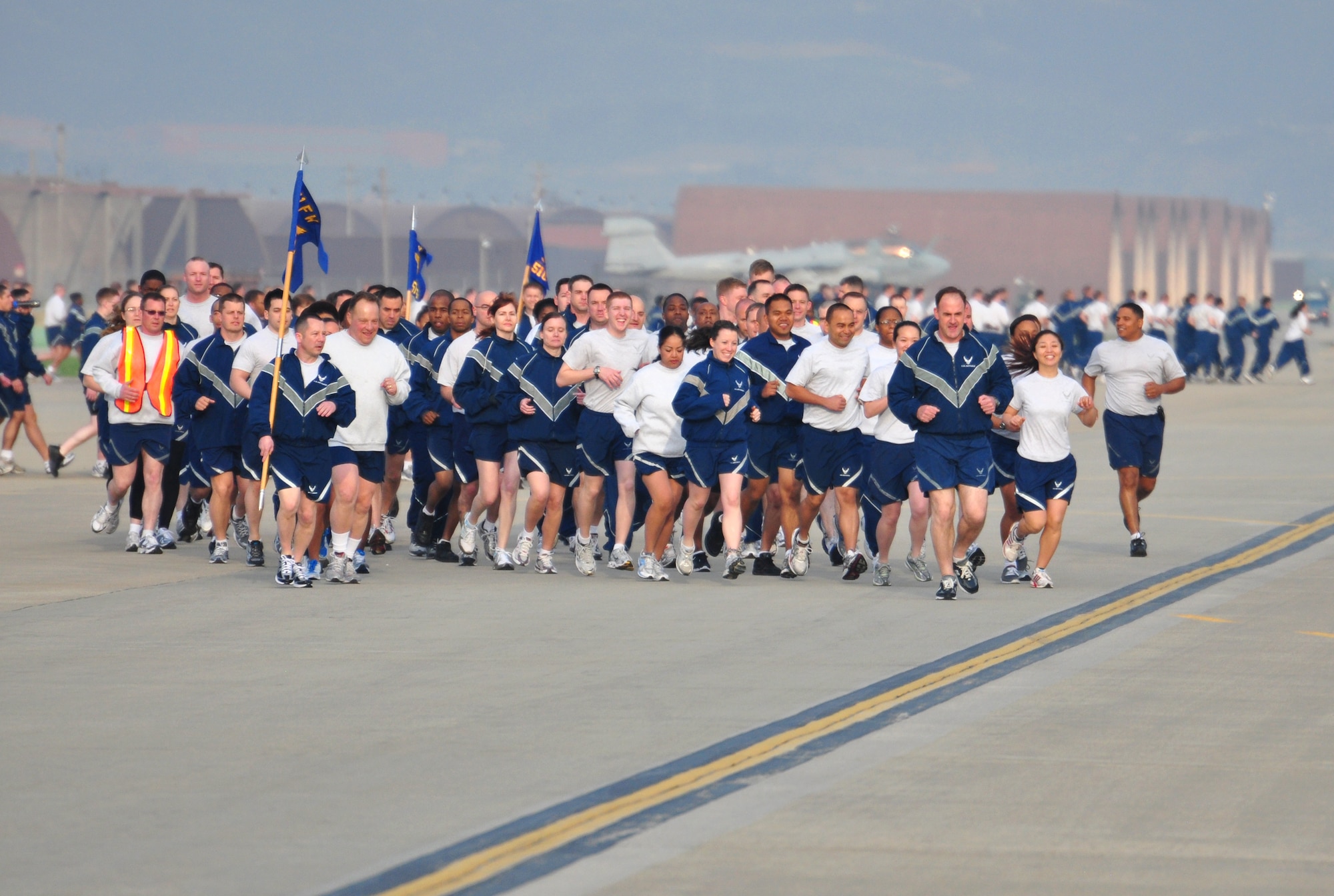 Col. Mark DeLong, 51st Fighter Wing vice commander, along with Airmen from the 51st Comptroller Squadron and wing staff agencies "lead the charge" during the fun-run here May 6. Airmen at Osan participated in a 5k fun-run and foreign object damage walk around the flightline that were sponsored by Air Force Assistant Fund coordinators. The event was used to congratulate the base on an exceptional fund raiser, which brought in more than $153,000 dollars this year. (U.S. Air Force photo/Staff Sgt. Chad Thompson)