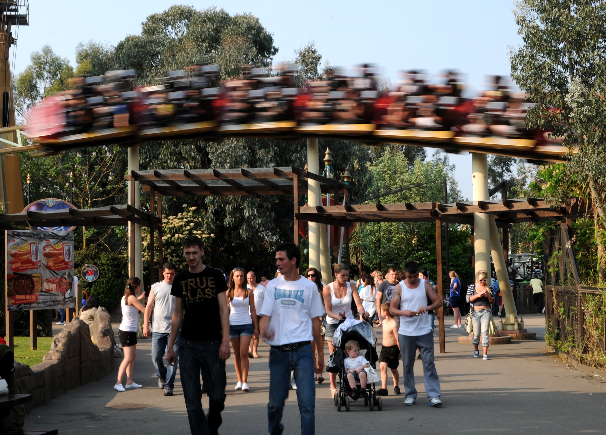 CHERTSEY, England - Visitors walk through Thorpe Park as the rollercoaster, "Colossus," zooms by overhead on April 24, 2011.  Liberty Warriors in an RAF Lakenheath Information, Tickets and Travel trip visited Thorpe Park. The RAF Lakenheath ITT offers trips and guided walking tours to destinations throughout the United Kingdom. (U.S. Air Force photo/Airman Cory Payne)