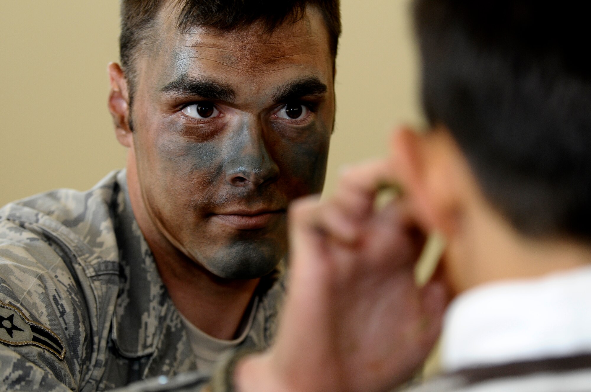 Airman 1st Class Mark Hughett, 31st Security Forces Squadron entry controller, camouflages a little boy’s face during the Aviano Children’s Deployment Line May 5. The 603rd Air Control Squadron hosted the simulated deployment line for children from Aviano elementary and middle schools, with help from volunteers from around the base, to help children better understand their parents’ duties in the military. (U.S. Air Force photo/Airman 1st Class Katherine Windish)