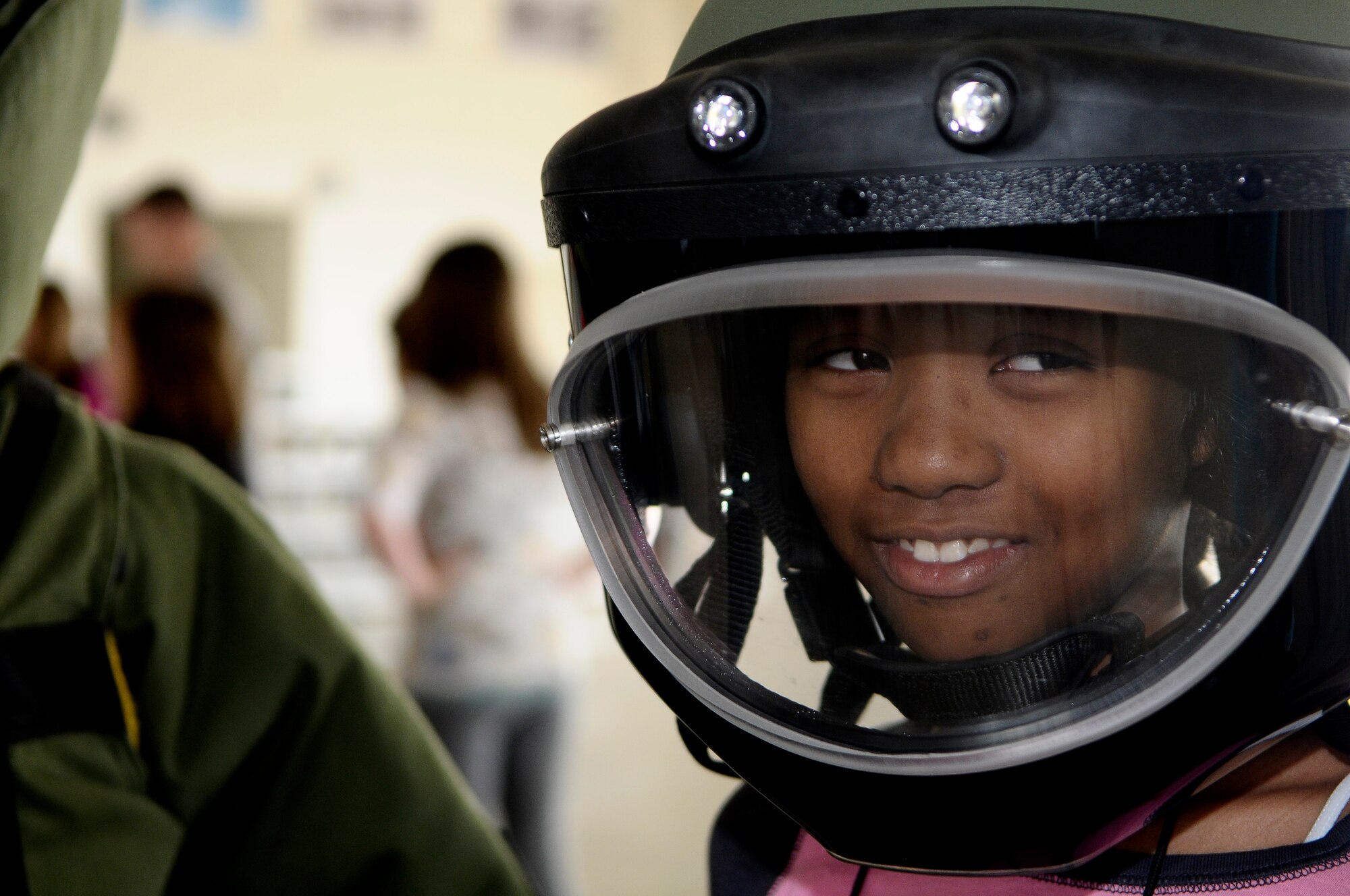 Audrey Gagum, daughter of Master Sgt. Alford Gagum, tries on gear used by explosive ordnance disposal technicians during the Aviano Children’s Deployment Line May 5. The 603rd Air Control Squadron hosted the simulated deployment line for children from Aviano elementary and middle schools, with help from volunteers from around the base, to help children better understand their parents’ duties in the military. (U.S. Air Force photo/Airman 1st Class Katherine Windish)