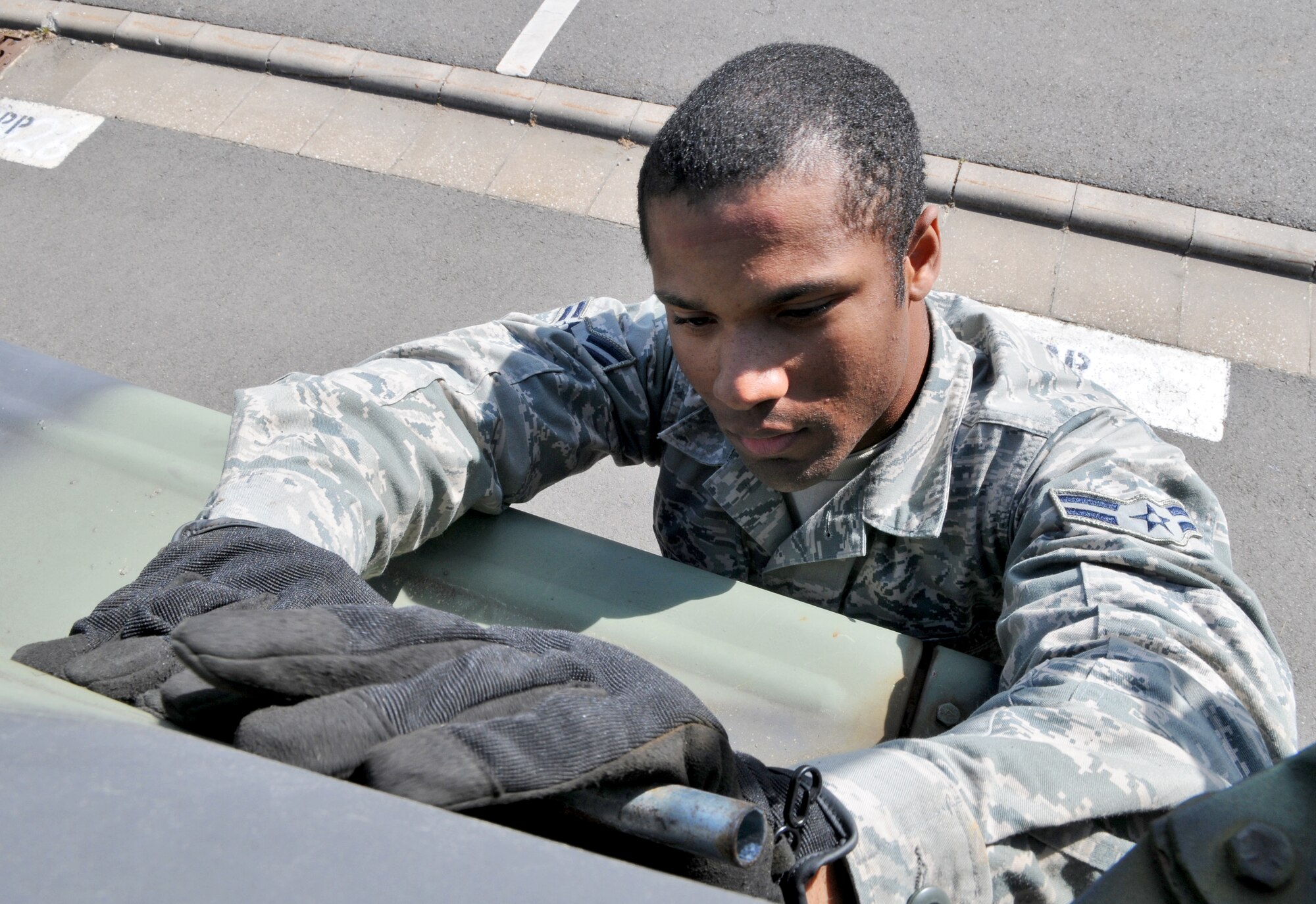 SPANGDAHLEM AIR BASE, Germany – Airman 1st Class Darryl Wilson, 606th Air Control Squadron surveillance technician, performs maintenance on a tactical vehicle here May 4 in preparation for an Eifel Thunder exercise. The exercise will test the ability of Airmen to take all their equipment to a simulated deployed location where they will live and work as if they are on a real deployment. (U.S. Air Force photo/Senior Airman Nick Wilson)