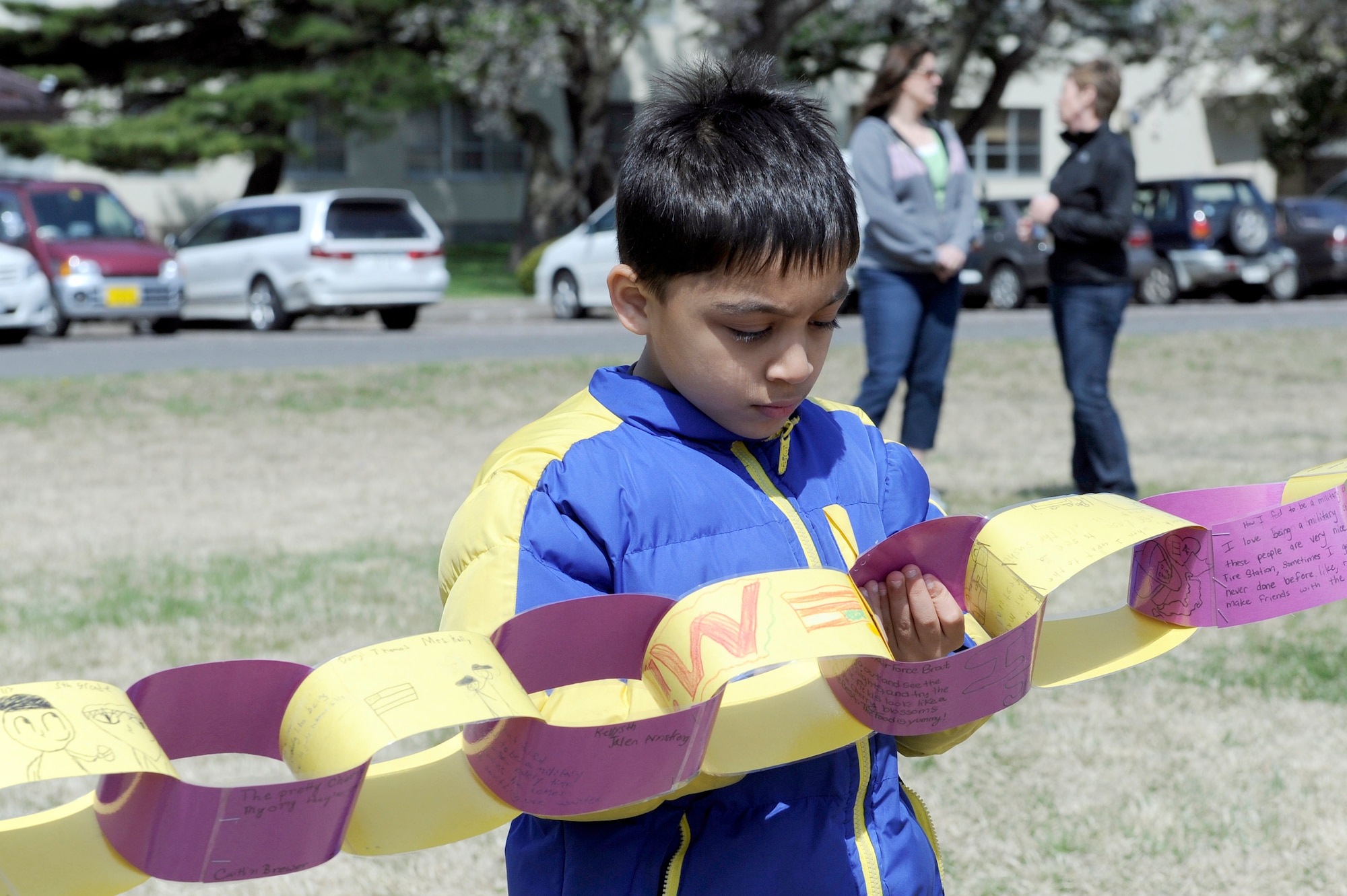 MISAWA AIR BASE, Japan -- Faris Sami, son of Petty Officer 1st Class Syed Sami, looks at the different links made by his classmates May 6. Approximately 200 links were made by students at Cummings Elementary to represent that particular child's feelings and thoughts about life as a military child. (U.S. Air Force photo/Staff Sgt. Marie Brown/Released)
