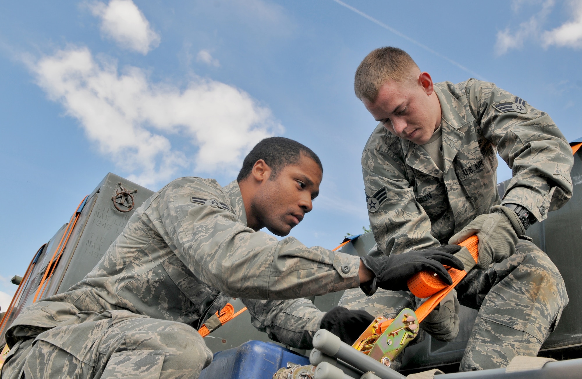 SPANGDAHLEM AIR BASE, Germany – Airman 1st Class Darryl Wilson (left) and Senior Airman Case Nielson (right), 606th Air Control Squadron surveillance technicians, load cargo onto a tactical vehicle here May 3 in preparation for an Eifel Thunder exercise. The exercise will test the ability of Airmen to take all their equipment to a simulated deployed location where they will live and work as if they are on a real deployment. (U.S. Air Force photo/Senior Airman Nick Wilson)