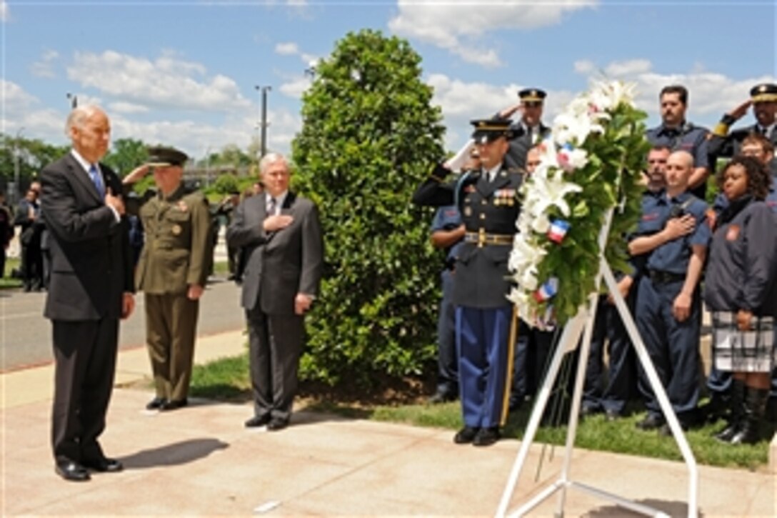 Vice President of the United States Joe Biden (left), Secretary of Defense Robert M. Gates (3rd from left) and Vice Chairman of the Joint Chiefs of Staff Gen. James E. Cartwright render honors as taps is played at a memorial wreath laying ceremony held at the Pentagon on May 5, 2011.  Looking on, as Biden placed the wreath at the site where terrorist-piloted American Airlines Flight 77 impacted the building killing 184 people, are a group of first responders from the Arlington County Fire Department.  Approximately 100 family members of those who perished in the attack were also in the audience.  