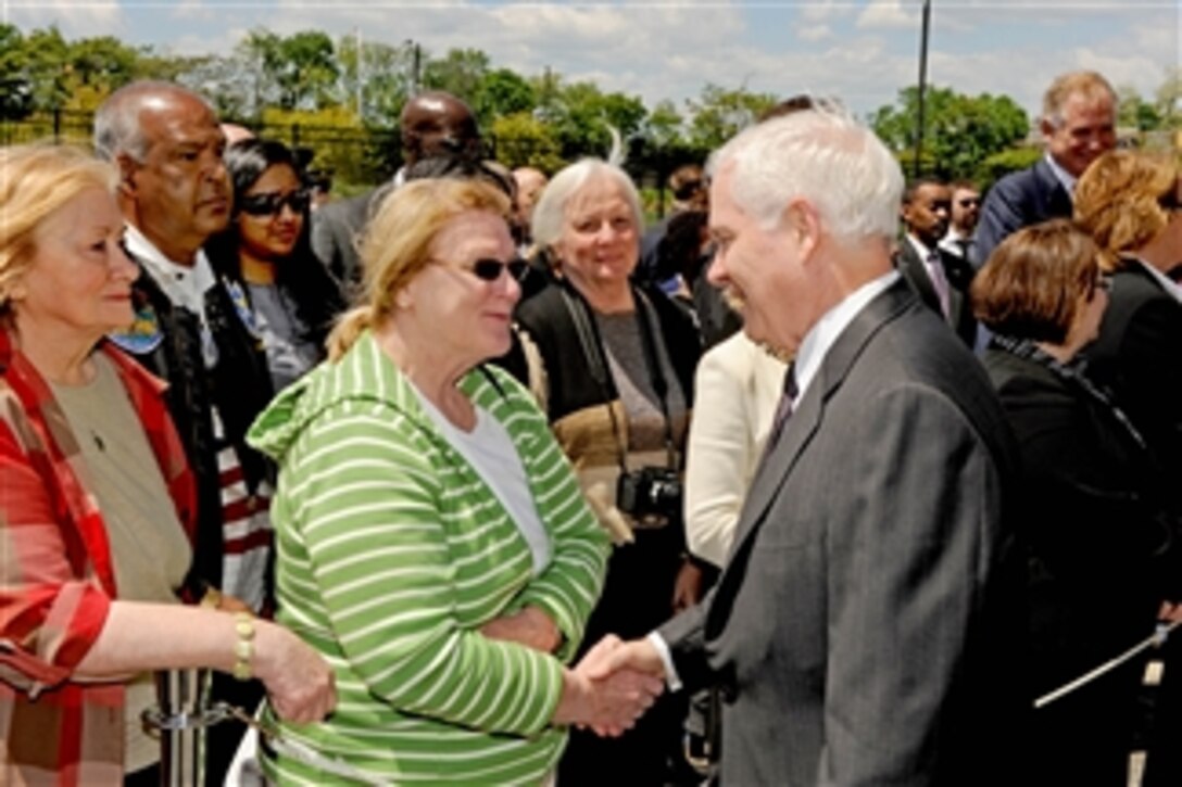 Secretary of Defense Robert M. Gates talks with family members of those who lost their lives in the Sept. 11, 2001, terrorist attack on the Pentagon during a wreath laying ceremony on May 5, 2011.  Gates was among several dignitaries who joined Vice President Joe Biden for a memorial at the site of the terrorist event that killed 184 people.  