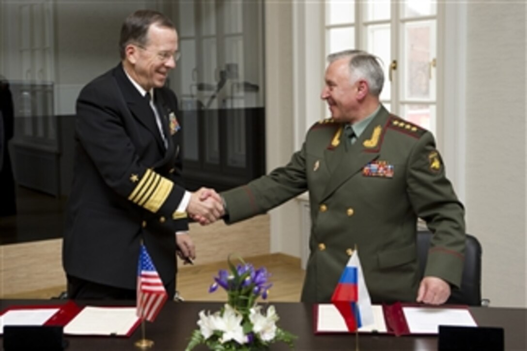 Chairman of the Joint Chiefs of Staff Adm. Mike Mullen congratulates Chief of the General Staff of the Armed Forces of Russia Gen. Nikolai Makarov after signing a memorandum of understanding to continue combating terrorism at the Russian Central Navy Museum in St. Petersburg, Russia, on May 6, 2011.  Mullen is on a three-day trip to the country to meet with his counterparts discussing issues of mutual interest.  