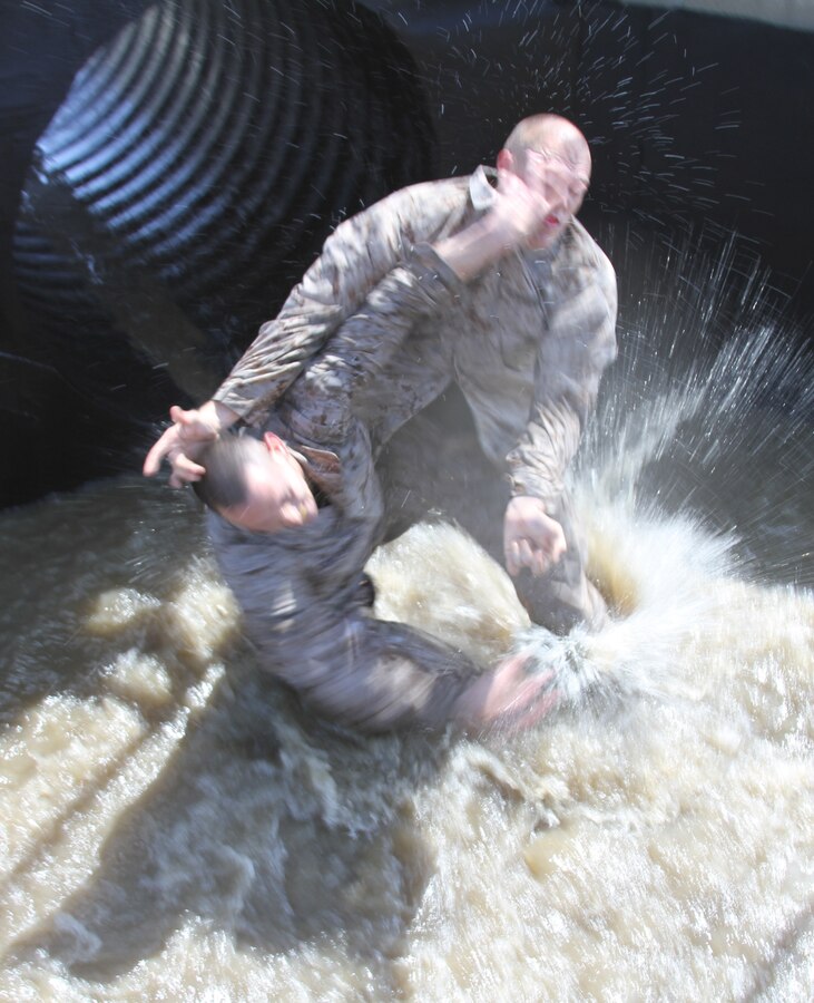 Sgt. Steven Gamet lunges onto Cpl. Nicholas Cortez in hopes to gain advantage and overpower Cortez.