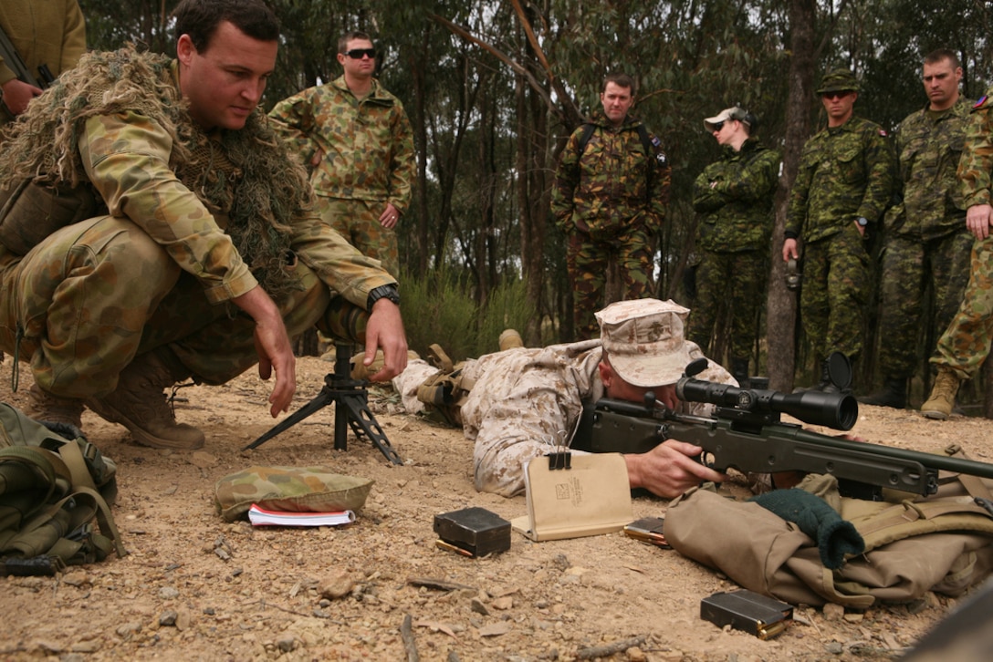 Lt. Col. Mark D. Mackey, right, officer-in-charge of Marine Shooting Detachment Australia, and OIC of Civil Affairs, III Marine Expeditionary Force, inspects an Australian SR-98 sniper rifle as Australian Army Cpl. Garth Cook, left, a sniper with 8th Battalion, 9th Royal Australian Regiment, answers questions here May 7 during the 2011 Australian Army Skill at Arms Meeting. Markmanship experts from several countries attended the demonstration during a break in the competition. AASAM is an annual, international combat marksmanship competition hosted by the Australian Army that will be held through May 19. (U.S. Marine Corps Photo by Lance Cpl. Mark W. Stroud/Released)