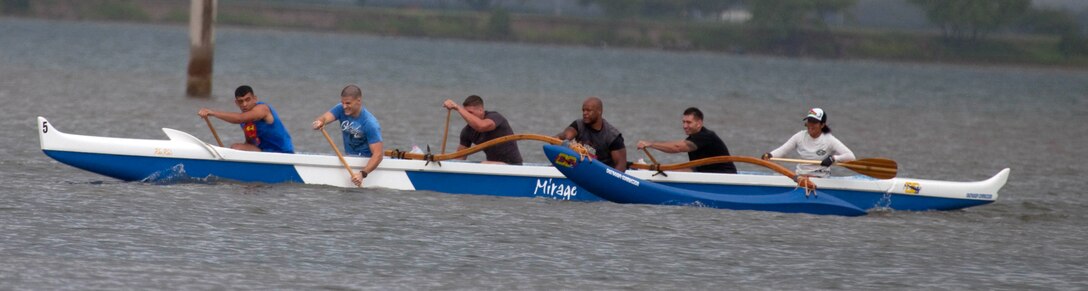 Protocol, a Marine canoe racing team, paddles furiously during the first heat of the 2011 All Military Canoe Regatta men’s division May 7 at the Rainbow Bay Marina, here. Protocol is composed of Marines from the Office of the Staff Secretary, U.S. Marine Corps Forces, Pacific. The first-time canoe racers decided to form a team after they received a taste of the sport during a physical training session a month ago.