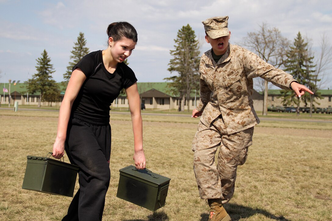 Pvt. Emily Taitt, 19, from Coon Rapids, Minn., motivates Ariel Arvidson, a 17-year-old junior at Coon Rapids High School, toward the finish line during a modified combat fitness test at the Recruiting Station Twin Cities mini boot camp May 7. Taitt, a 2010 Blaine High School graduate who enlisted out of the Coon Rapids office, completed boot camp April 15. For additional imagery from the event, visit www.facebook.com/rstwincities.