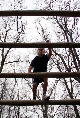 Dylan Lovelace, a 17-year-old senior at Coon Rapids High School, carefully makes his way through the log pyramid portion of an obstacle course during the Recruiting Station Twin Cities mini boot camp May 7. Lovelace, who ships off for boot camp June 27, was recruited out of the Coon Rapids office by Staff Sgt. Jowa J. Wildes. For additional imagery from the event, visit www.facebook.com/rstwincities.