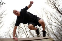 Martin Bottila, a 17-year-old junior at Forrest Lake High School, clears a reverse-slanting wall while running through an obstacle course during the Recruiting Station Twin Cities mini boot camp May 7. Bottila attended the three-day boot camp as a guest out of the Coon Rapids recruiting office. For additional imagery from the event, visit www.facebook.com/rstwincities.